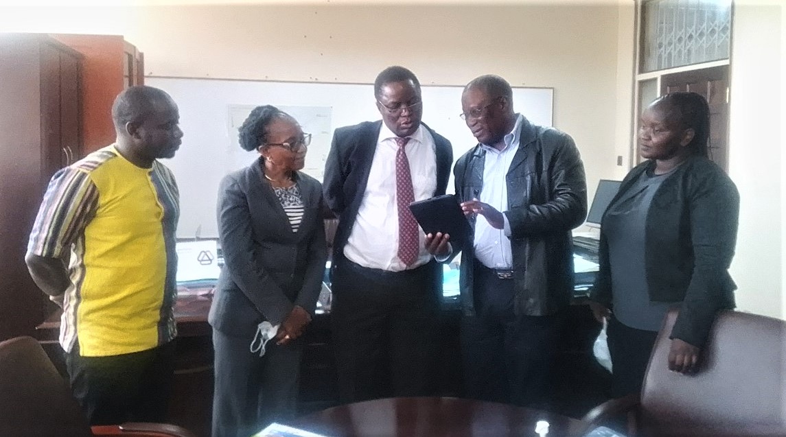 Mr. Justin Chuunka demonstrating to the Permanent Secretary Mr Green Mbozi, Ministry of Agriculture, how the ECAAS Tool is used in agricultural data collection. The meeting was attended by Precious Mwape, Peggy Mlewa, David Ongo, Eunice Wangui and Julius Buyengo. Missing in the photo is Mr. Justin Chuunka.